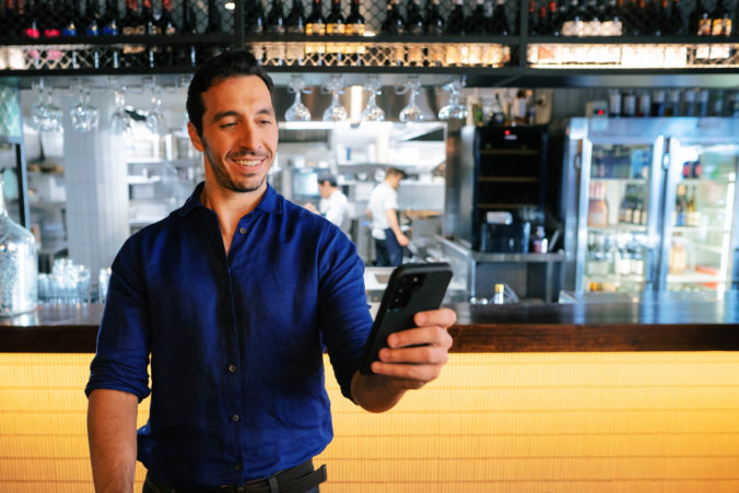 tyro-eftpos-blue-shirt-man-holding-phone