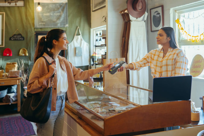 a person tapping a EFTPOS card on a EFTPOS machine