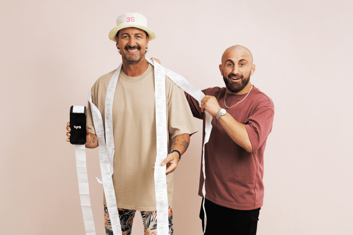 Volk and Nicka holding a Tyro Pro with a long receipt