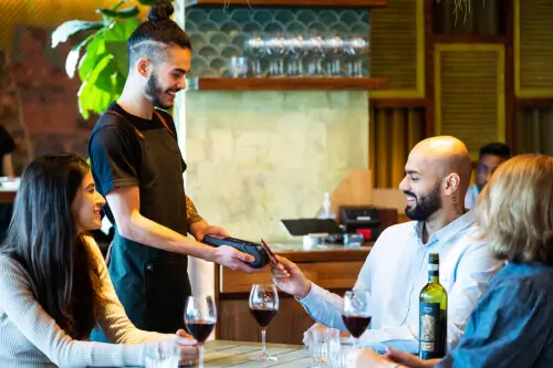 Waitress taking EFTPOS payment at the table
