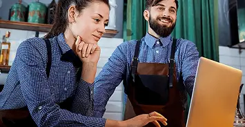 Cafe workers on laptop