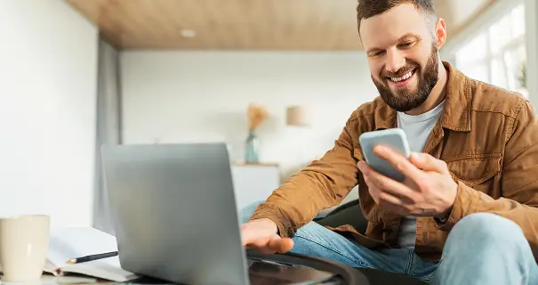 Person on laptop and phone