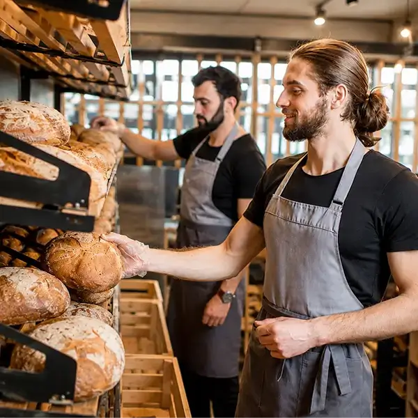Person picking a loaf of bread
