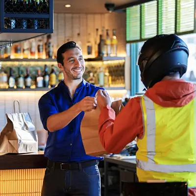 Person handing food back to delivery driver