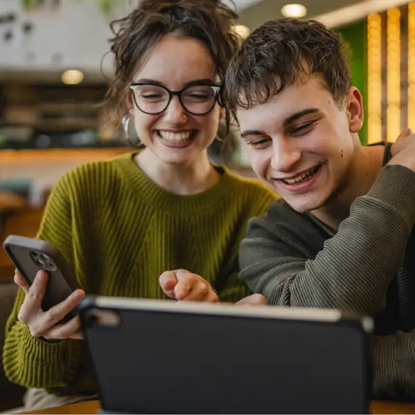 Person smiling at tablet