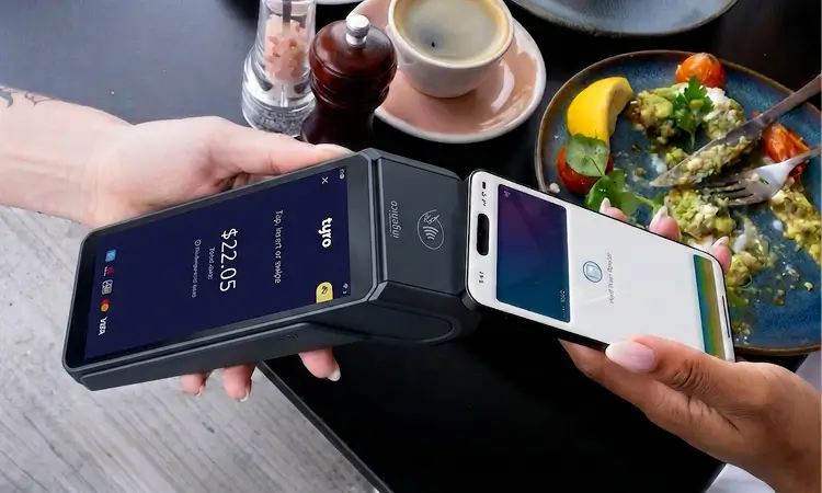 Tyro Pro Touch tapping mobile outside cafe