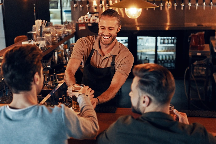 server serving beer in pub