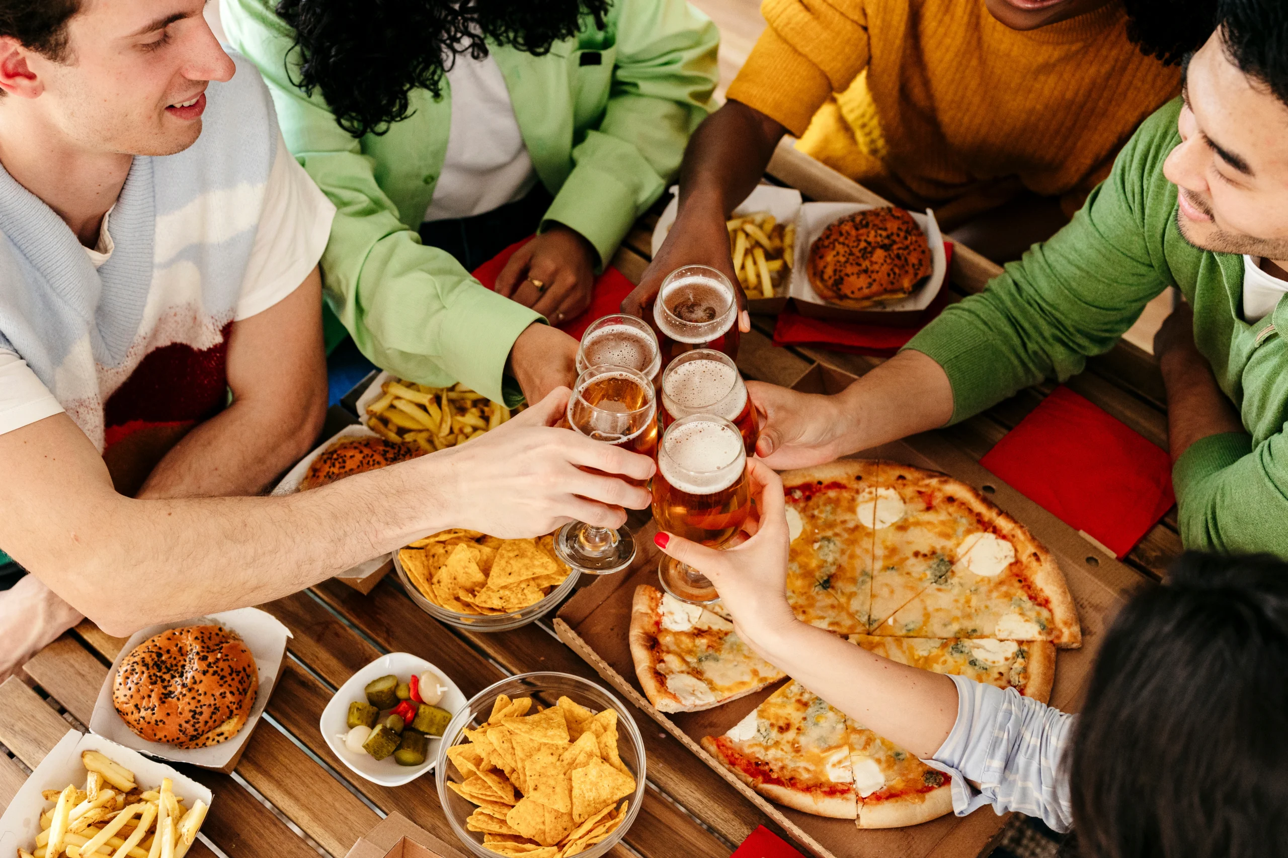 People sharing beers and food in pub