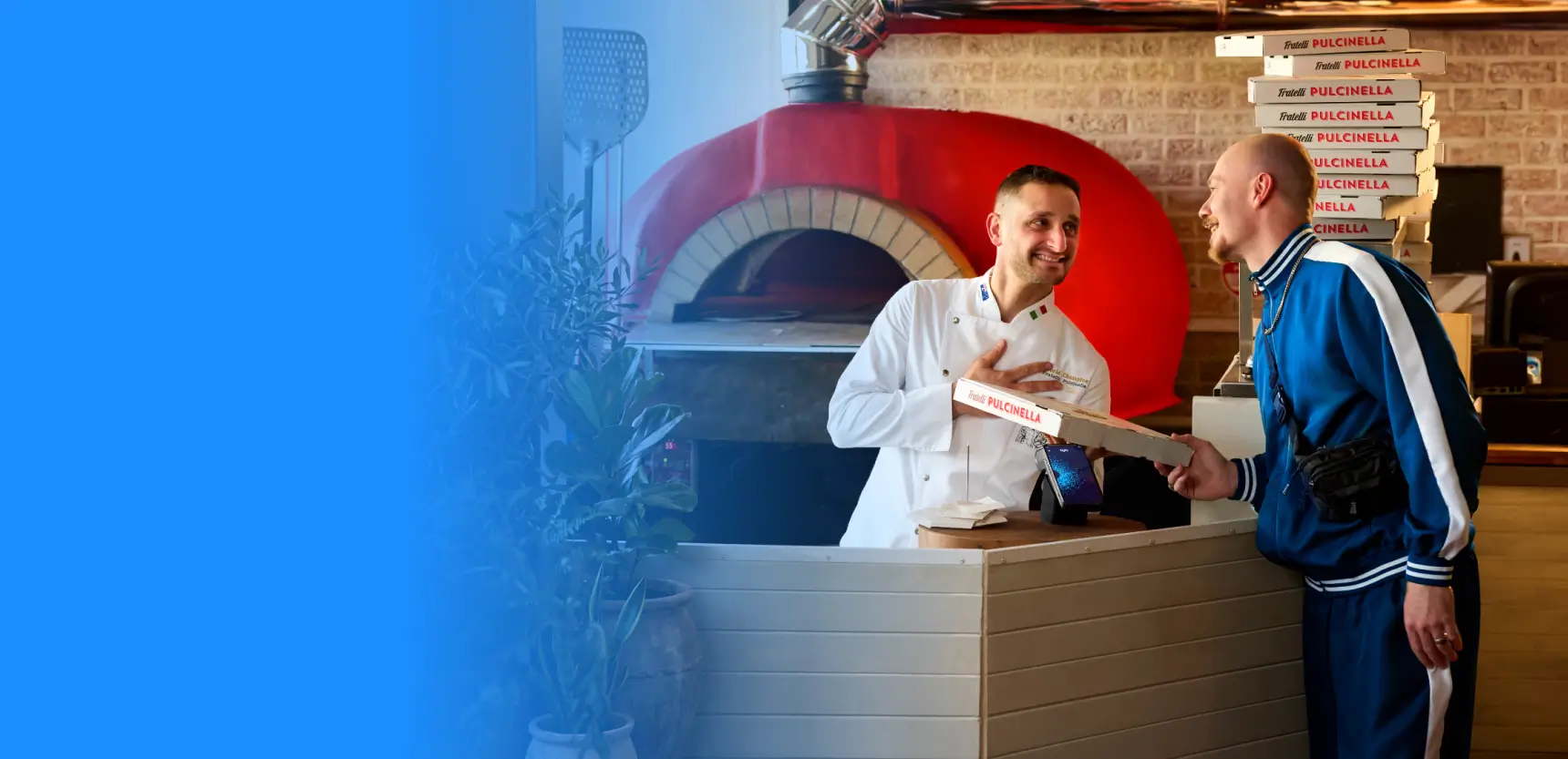People laughing tapping a pizza box onto a tyro pro touch